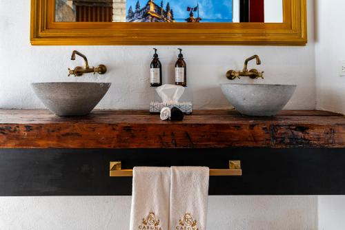 two sinks on top of a wooden counter with towels at HOTEL BOUTIQUE CASONA 65 in Puebla