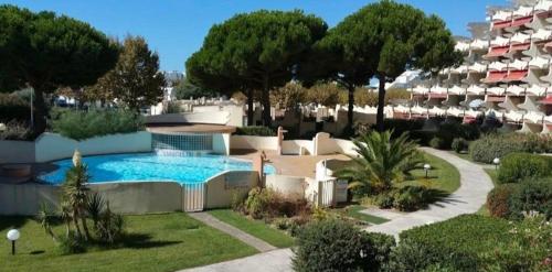 un complexe avec une piscine dans une cour dans l'établissement Studio a la mer piscine wifi parking clim, à La Grande Motte