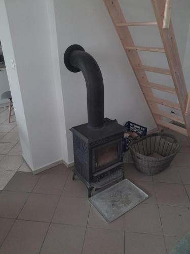 a black stove sitting on a floor in a room at Domek Gościnny nad jeziorem Limajno in Olsztyn