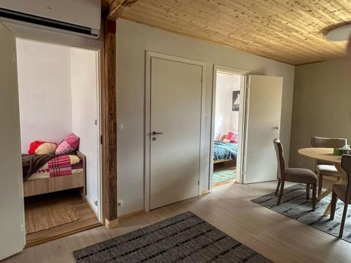 a room with a bedroom with a bed and a table at Your getaway home in Jausa küla in Hiiumaa