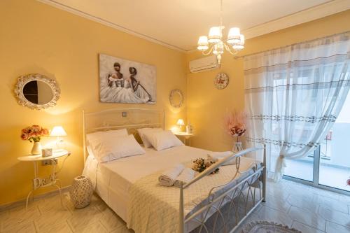 a bedroom with a bed and a large window at Erofili's Apartment ONLY 700 meters from the beach in Ialyssos