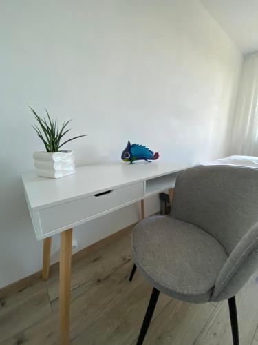 un escritorio con una silla y un juguete de pescado. en Apartament Kasia en Wałbrzych