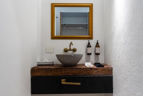 a bathroom with a sink and a mirror at HOTEL BOUTIQUE CASONA 65 in Puebla