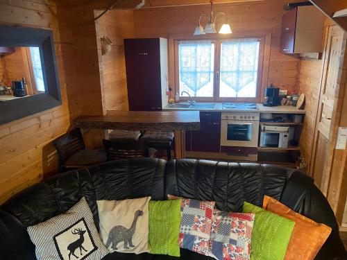 a living room with a couch and a kitchen at Faakersee - Familyhouse - mit PrivatStrand- Only Sa-Sa in Egg am Faaker See