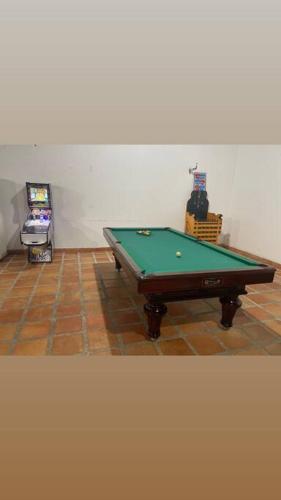 a ping pong table in a room with a video game at Finca Rozo in Palmira