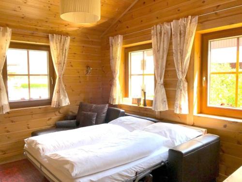 a bedroom with a large bed in a log cabin at gemütliches Tiroler Blockhaus in Aschau