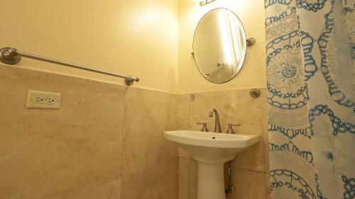 a bathroom with a sink and a mirror at Royal Palms Estate in Christiansted