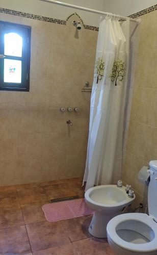 a bathroom with a toilet and a shower at LA MAISON in Lozano