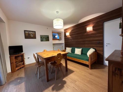 a living room with a table and a couch at Residenza Sertorelli in Bormio