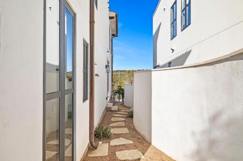 an alleyway between two buildings with white walls at Las Luces in Spicewood