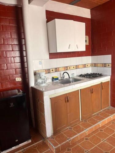 uma cozinha com um lavatório e um fogão em Aparta estudio Jamundí em Potrerito