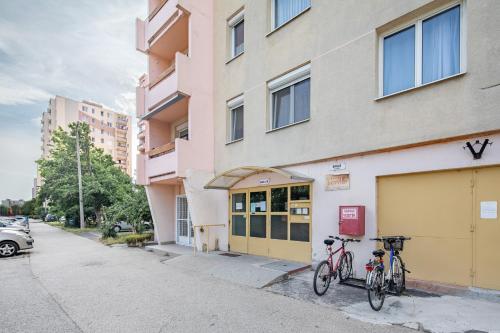 two bikes parked on the side of a building at LIZO 2 apartman in Székesfehérvár
