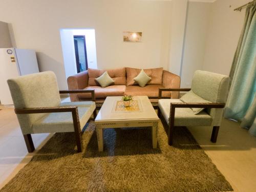 a living room with two chairs and a couch at Blue Residence Dahab in Dahab