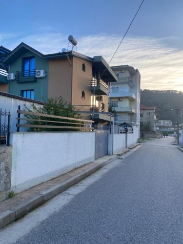 an empty street with houses and a fence at Vila Ajdinaj in Berat