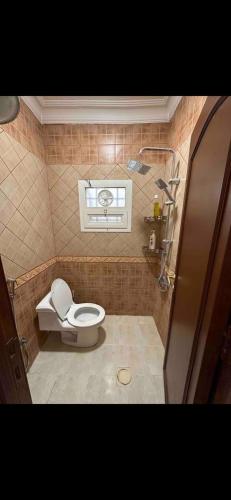 a bathroom with a toilet and a window at استديو بتصميم عصري ومريح في موقع مميز in Riyadh