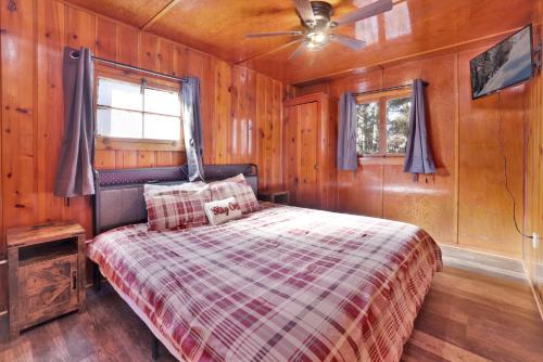 a bedroom with a bed and a ceiling fan at Little Pines Couples Lakeside Cabin by Big Bear Vacations in Big Bear Lake