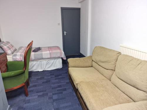 a living room with a couch and a bed at Room near East Midland Airport Room 5 in Kegworth