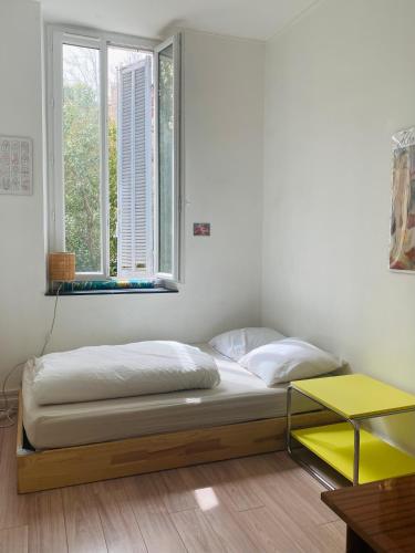 a bed sitting in a room with a window at Petite chambre sur cour aborée in Marseille