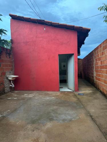 un edificio rojo con una pared roja y una puerta en Flat Nogueira, en Palmas