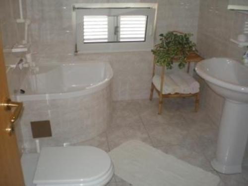 een badkamer met een toilet, een bad en een wastafel bij Appartment mit wunderschoenen Panoramablick zum Meer und Marina in Novi Vinodolski