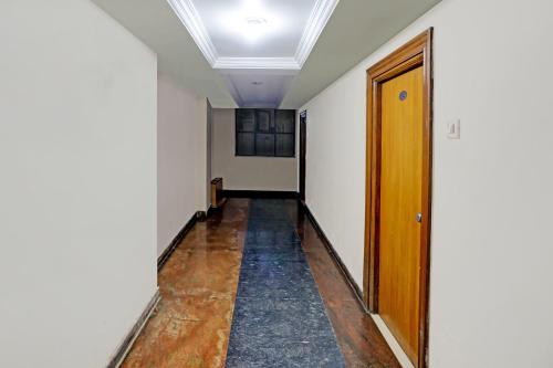 a hallway with a wooden door in a room at SPOT ON Hotel Rk Residency Near MGBS Bus station in Hyderabad