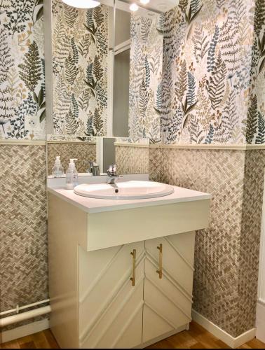 une salle de bain avec un lavabo et un miroir dans l'établissement sainte cecile, à Sainte-Cécile-Plage