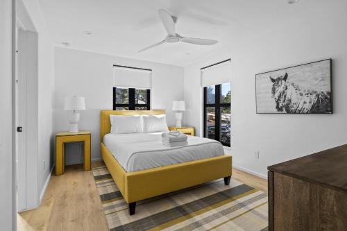 a bedroom with a bed and a painting of a horse on the wall at Las Luces in Spicewood