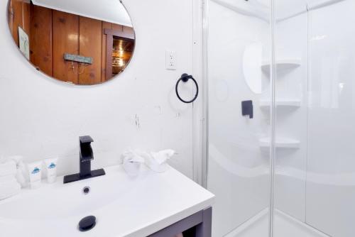 a white bathroom with a sink and a mirror at Big Pines Couple Lakeview Studio Cabin by Big Bear Vacations in Big Bear Lake