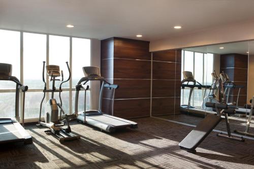 a gym with treadmills and ellipticals in a building at Best Western Papilio Hotel in Surabaya