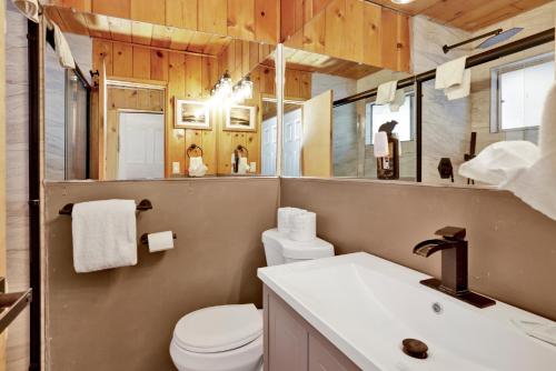 a bathroom with a toilet and a sink at Sunrise Lakefront Family Cabin by Big Bear Vacations in Big Bear Lake
