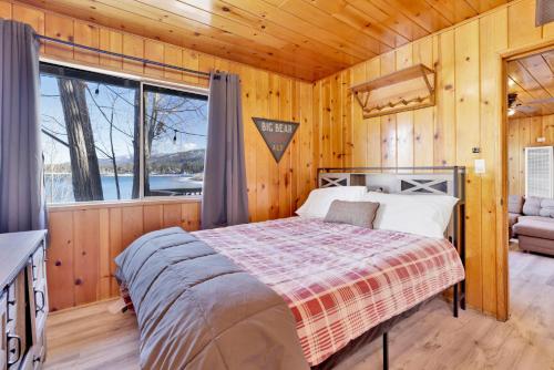 a bedroom with a bed in a room with a window at Sunrise Lakefront Family Cabin by Big Bear Vacations in Big Bear Lake