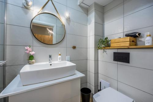 a bathroom with a white sink and a mirror at One Bedroom Apt - Close to Valletta in Hamrun