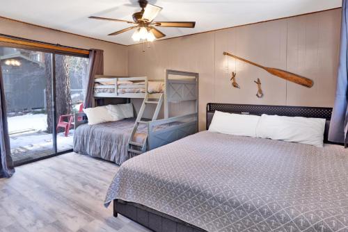 a bedroom with two beds and a ceiling fan at Lakefront Family Cabin by Big Bear Vacations in Big Bear Lake