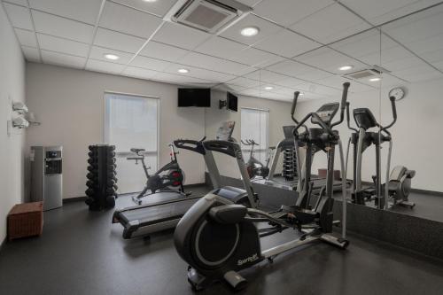 a gym with several tread machines in a room at City Express by Marriott Queretaro Jurica in Querétaro