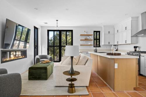 a kitchen and living room with a couch and a table at Las Luces in Spicewood