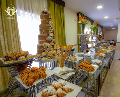 a buffet line with many different types of pastries at Manarat Gaza Hotel - Al Haram Tower in Makkah