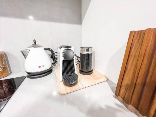 a kitchen counter with a coffee maker and a blender at City Centre - Pool - Parking - Self check-in in Canberra
