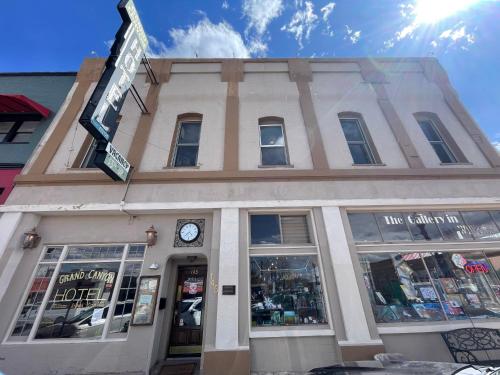 a building with a clock on the front of it at The Historic Grand Canyon Hotel in Williams
