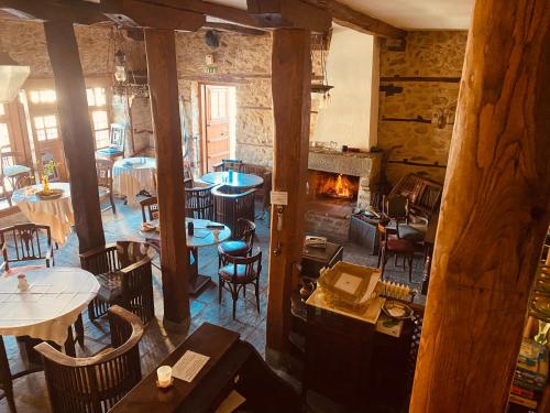 an overhead view of a restaurant with tables and a fireplace at Aristotelous Alexandrou Historic Inn in Arnaia