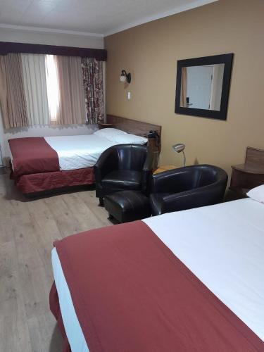 Ένα ή περισσότερα κρεβάτια σε δωμάτιο στο Travellers Motel