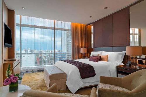 a bedroom with a large bed and a large window at The St. Regis Mexico City in Mexico City