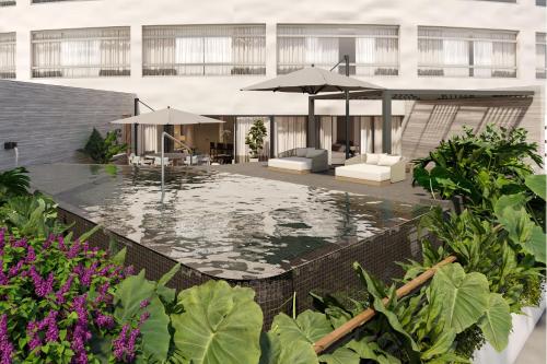 a courtyard with a pool with umbrellas and chairs at The St. Regis Mexico City in Mexico City