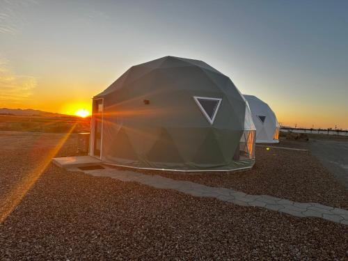 two tents on the side of a road at sunset at The Cowboy Glamping Dome in Willcox