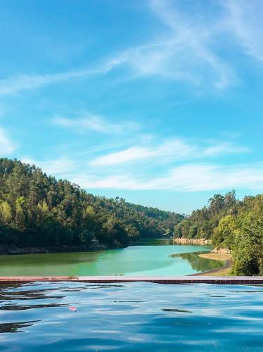 a large body of water with trees in the background at Quinta da Azenha in Amarante