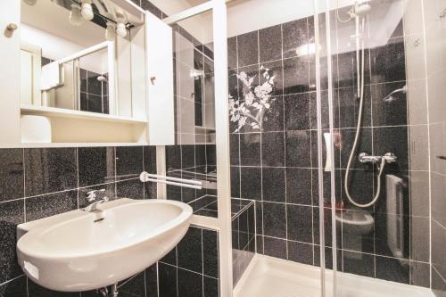 a bathroom with a sink and a shower at Lario Elegante in Menaggio