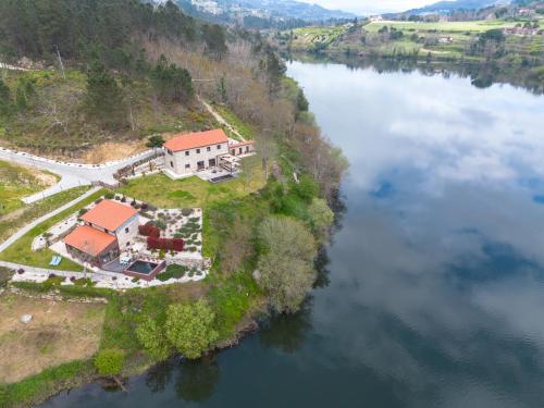 an aerial view of a house on an island in a river at Quinta da Azenha in Amarante