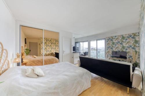 a bedroom with two beds and a large mirror at *Le sublime* vue sur la tour Eiffel / JO 2024 in Saint-Maurice