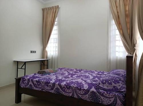 ein violettes Bett in einem Zimmer mit Fenster in der Unterkunft Villa Senitaman Organik in Seremban