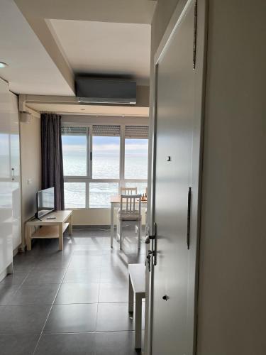 a living room with a table and a window at Torrenostra Sea Dream in Torreblanca