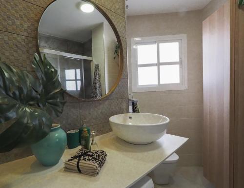 a bathroom with a sink and a large mirror at Ollerías 35 by Nagoa Homes in Málaga